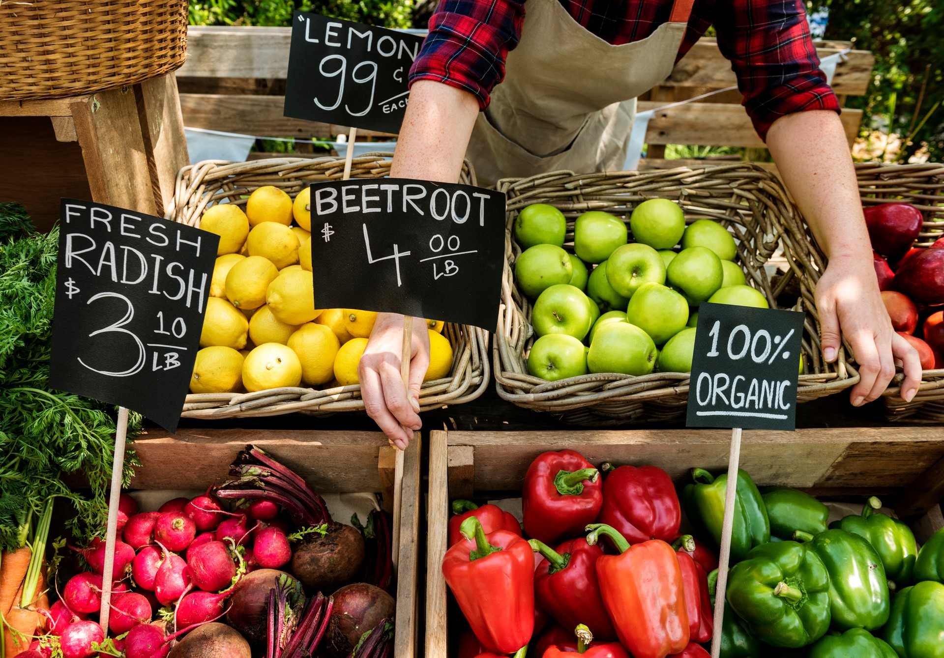 Greengrocer preparing organic fresh agricultural product at farmer market