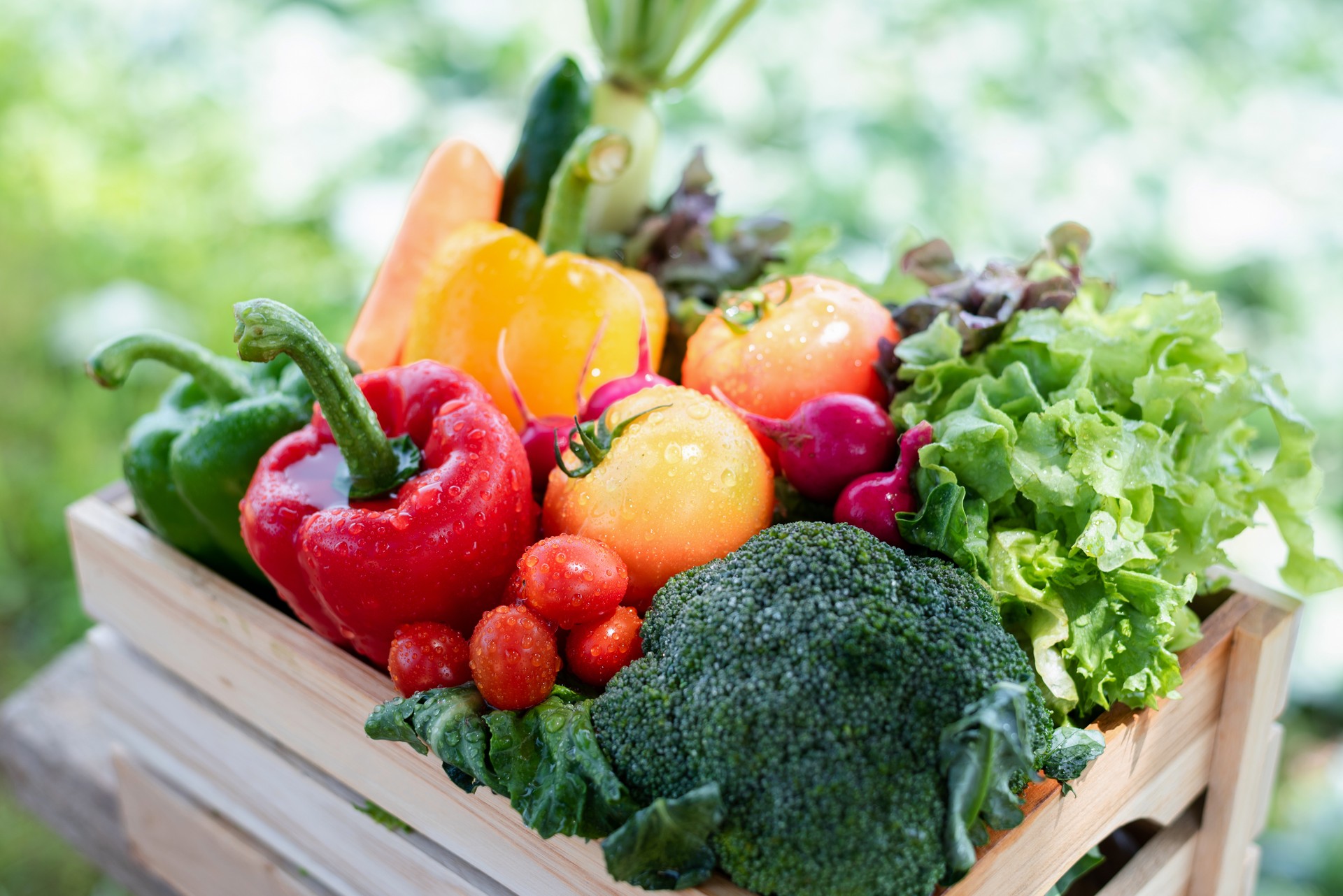 Crate filled with a large selection of healthy fresh organic fruits and vegetables shot.