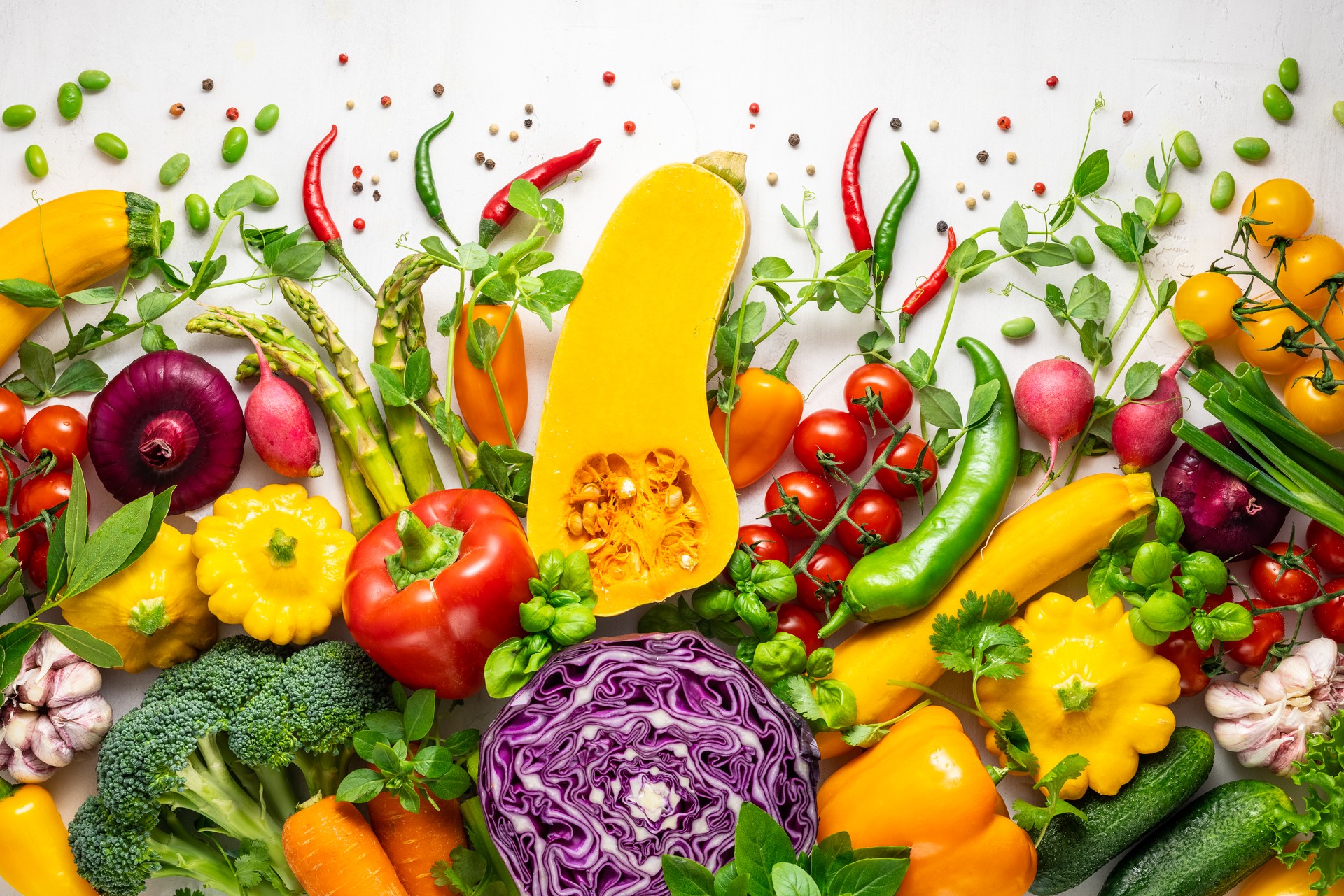 Fresh assorted vegetables and herbs on white background